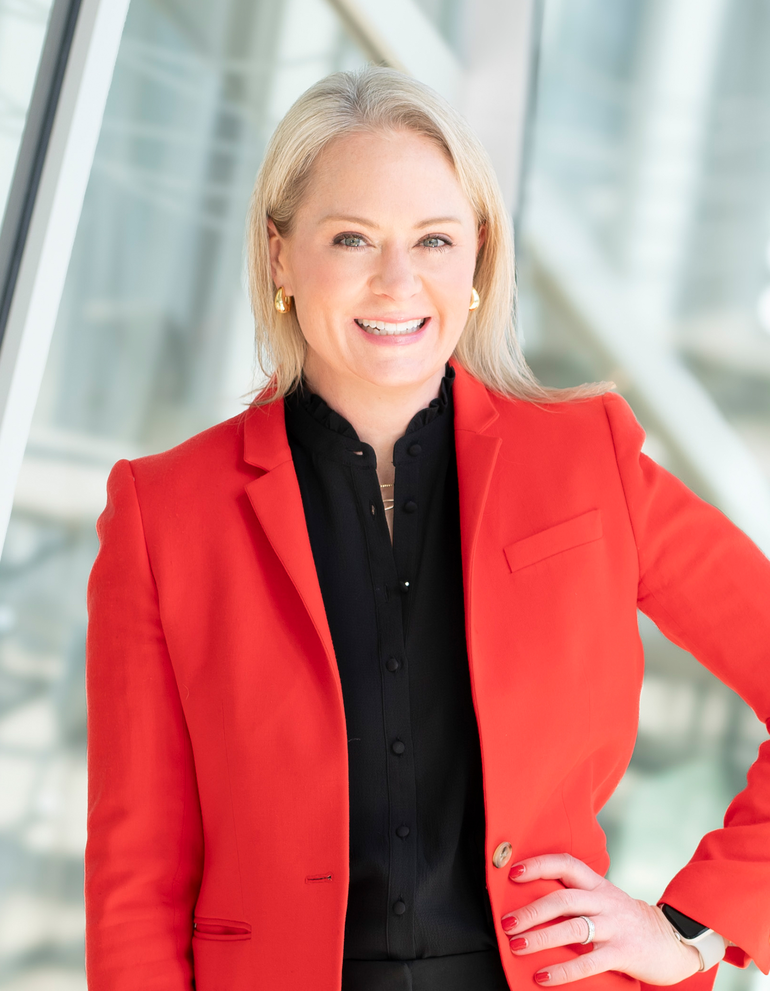 Kristin B. Johnson, attorney at the Virginia-based law firm Woods Rogers seen posing for a photo in red and black combination outfit